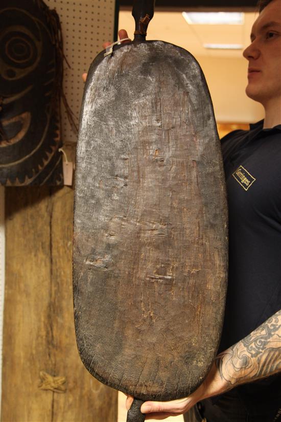 A Sepik River archers shield, another shield and three carved boards